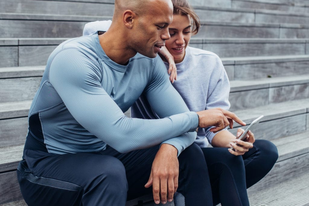 couple checking phone after running